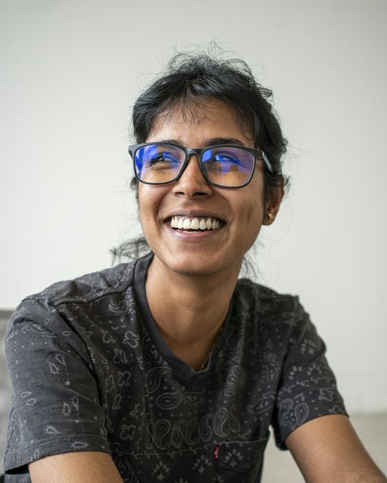 A woman in glasses laughing